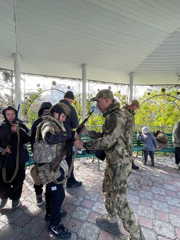 Російський бойовик дає дитині автомат