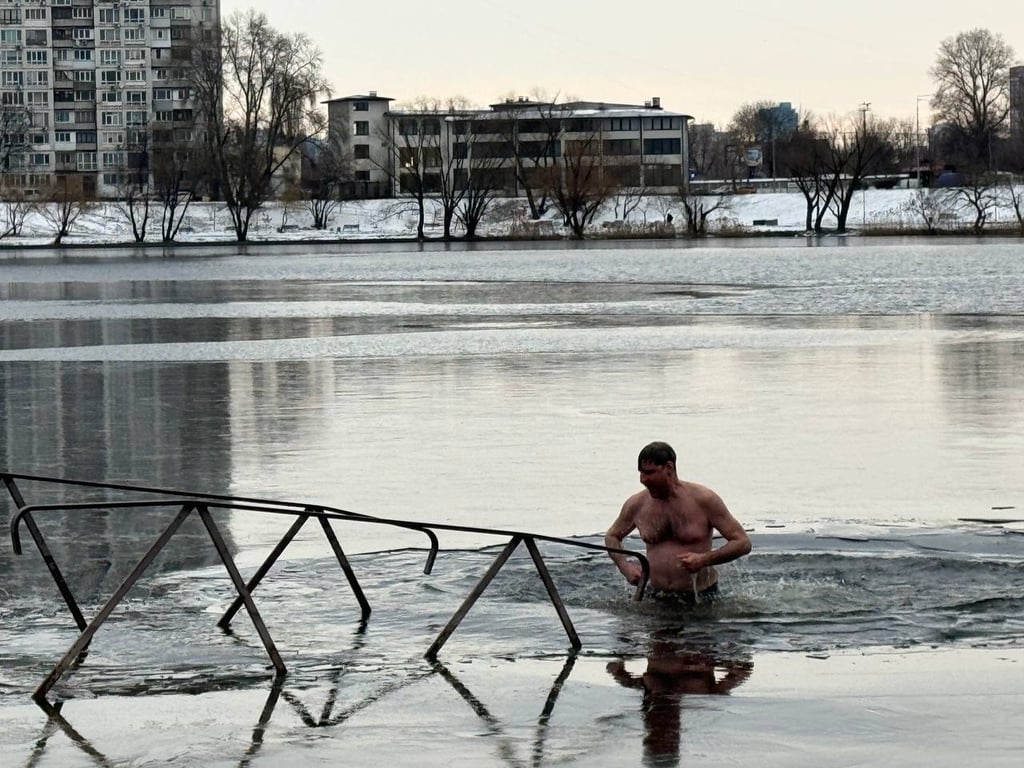 Человек купается в ледяном озере.