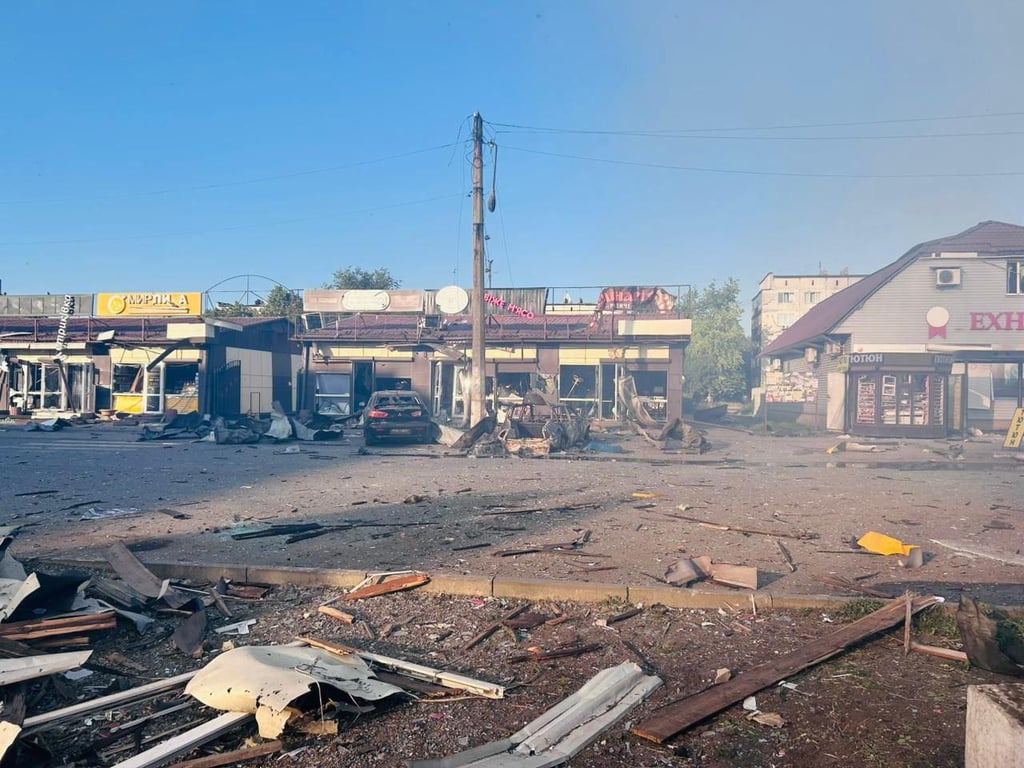 Burnt cars near a shopping center after a Russian attack on Dobropillia