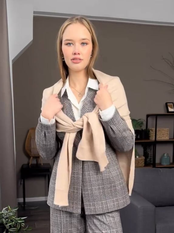 A sweater thrown over the shoulders looks trendy.