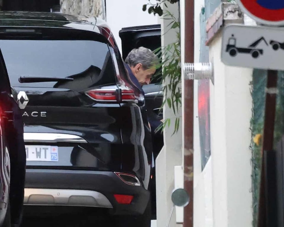 ormer French President Sarkozy arrives at his house after being released from jail in Paris