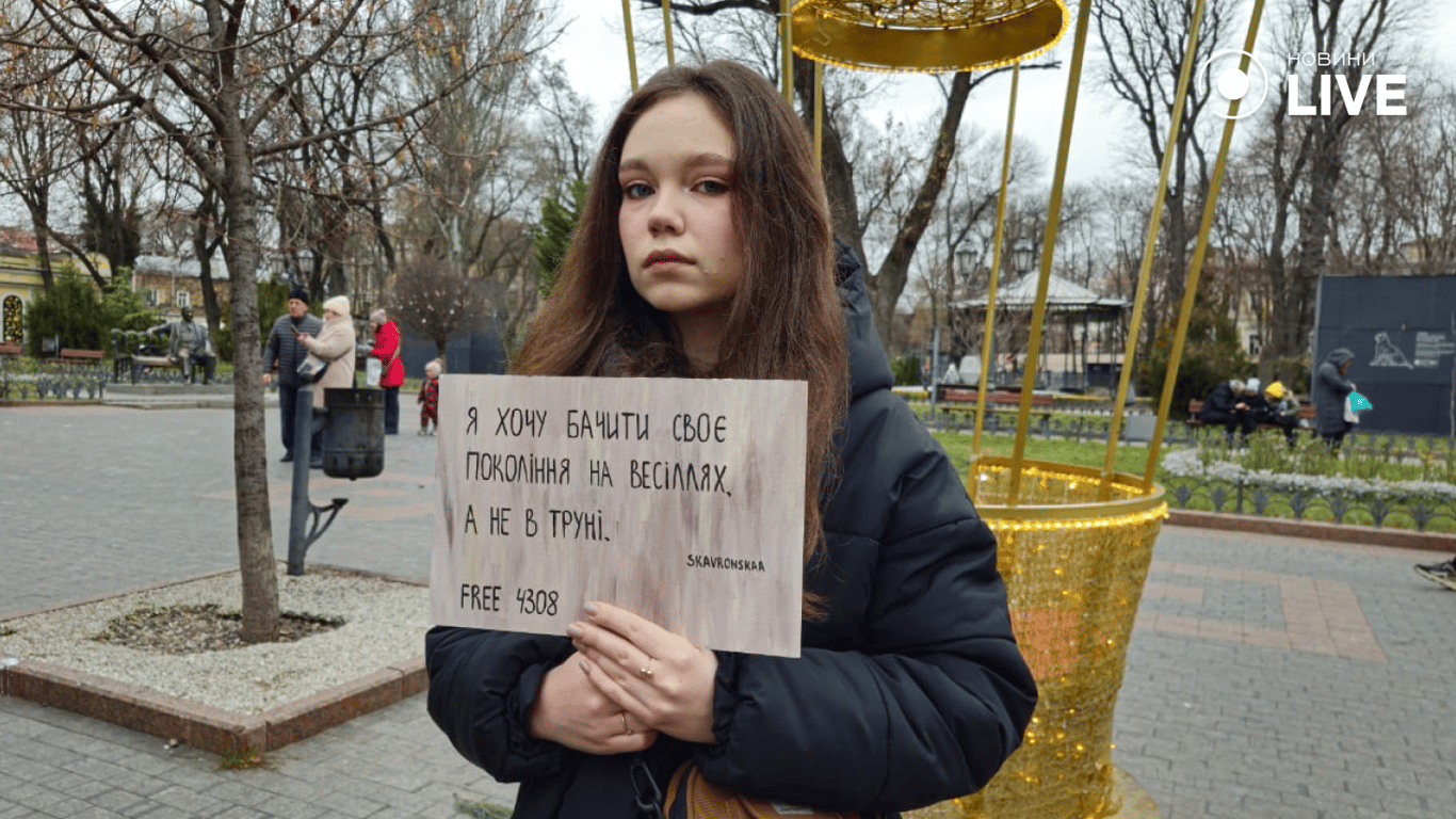 Дівчина з плакатом у руках на Дерибасівській