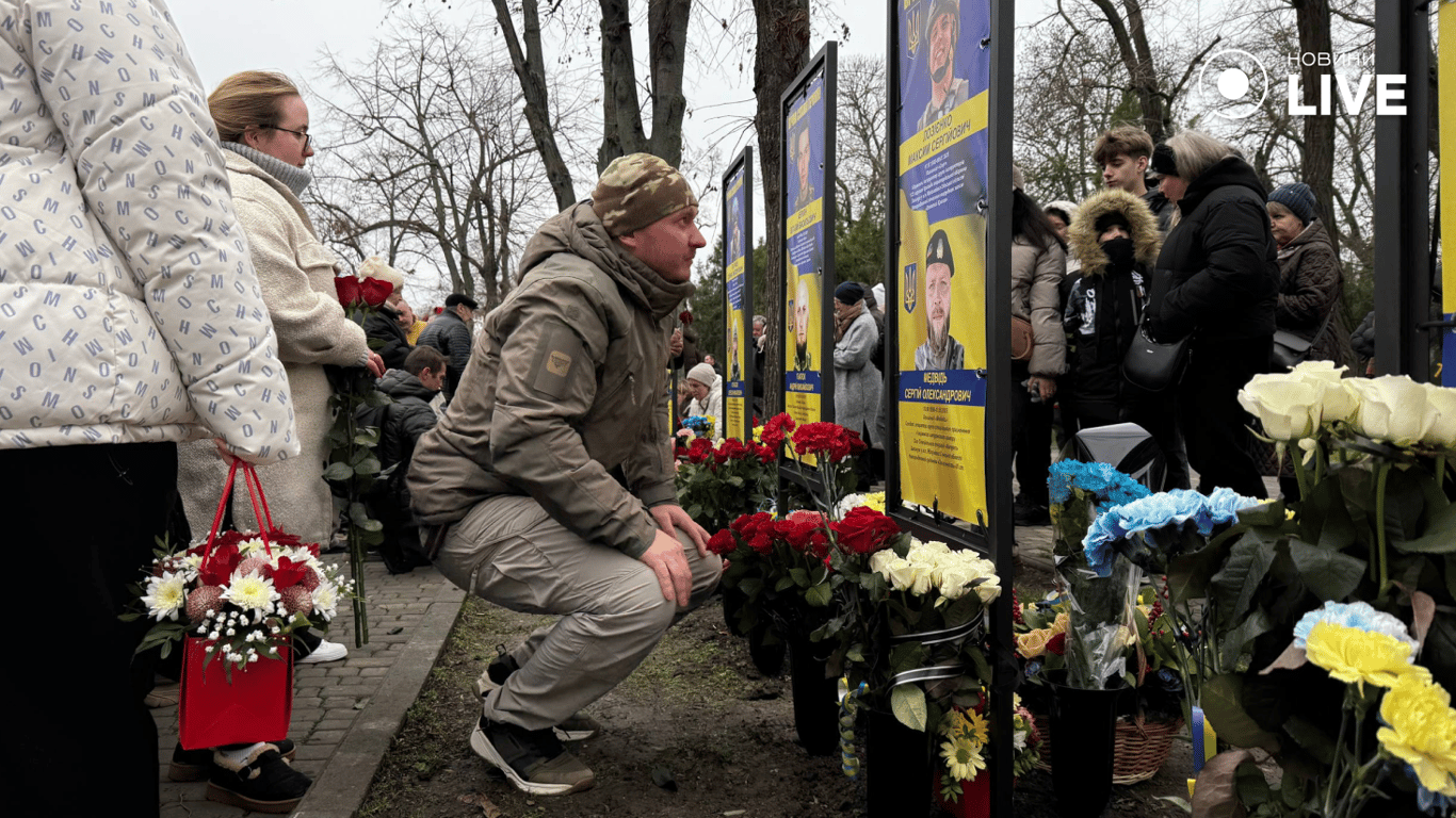 Військовий біля портретів полеглих воїнів